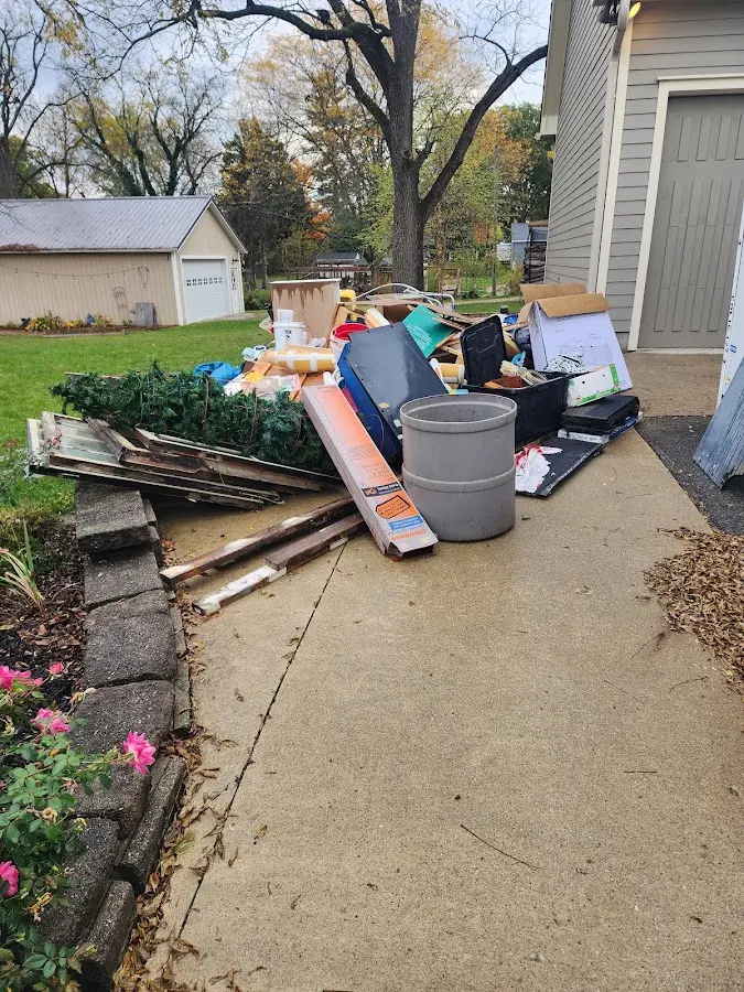 Dumpster being loaded with debris for Estate Cleanout Dumpster Rental in Skiatook